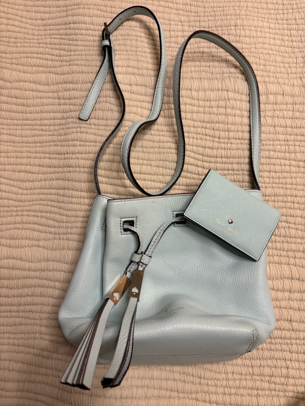 kate spade light blue leather drawstring crossbody with tassels and card pouch